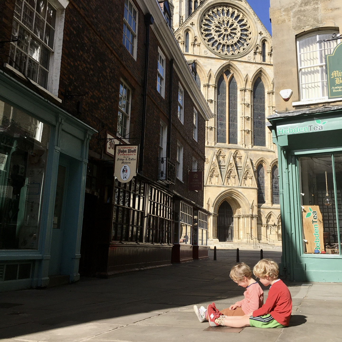 This photo was taken on Tuesday 7th April. I was trying to get a snap of the Minster peeping through and suddenly my sons ran in and sat like this. I thought it was a lovely moment of quiet friendship in the deserted streets of York.
 © Laura Bird