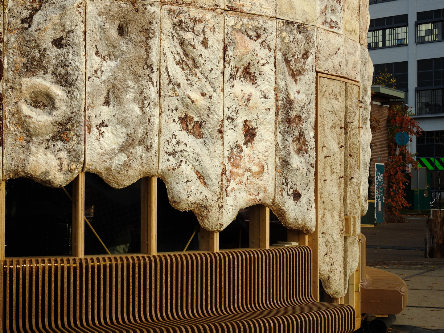 Facade of The Growing Pavilion is covered with mycelium panels designed by Krown.bio. The benches are made of rice straw ECO-Boards by Fiction Factory © Photos Eric Meander